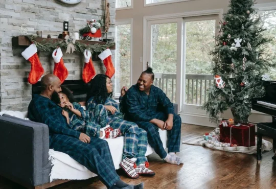 happy black family in Christmas-themed living room - Seasonal Shifts: Easy Ways to Revitalize Your Home Decor