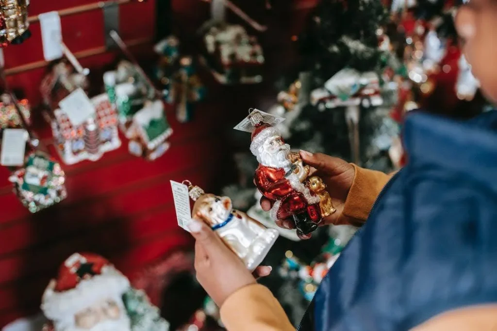 girl choosing holiday decor for Christmas tree