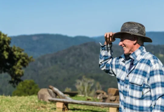 man wearing blue and white plaid shirt and black hat