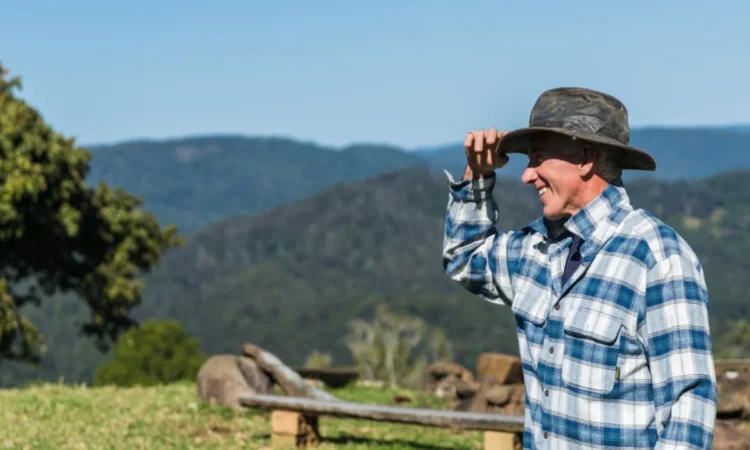 man wearing blue and white plaid shirt and black hat